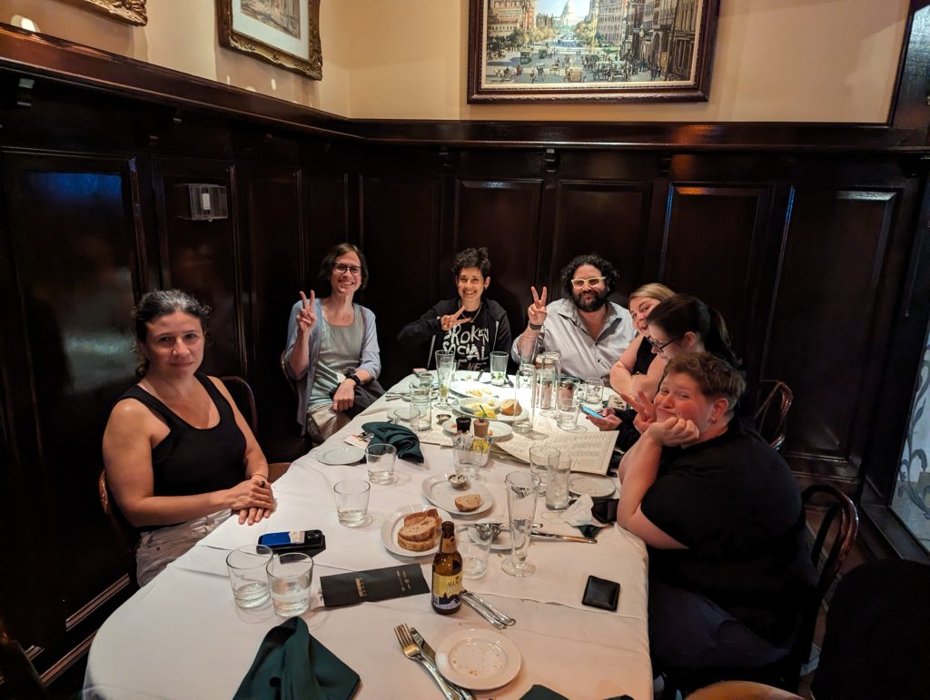 Seven people smiling around a table.