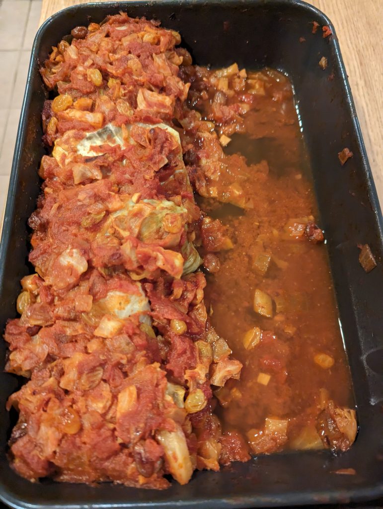 A pan with cabbage rolls in a tomato sauce.