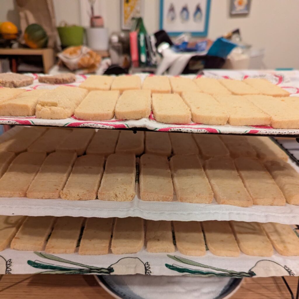 A 3-level rack with lemon shortbread cookies filling each level.